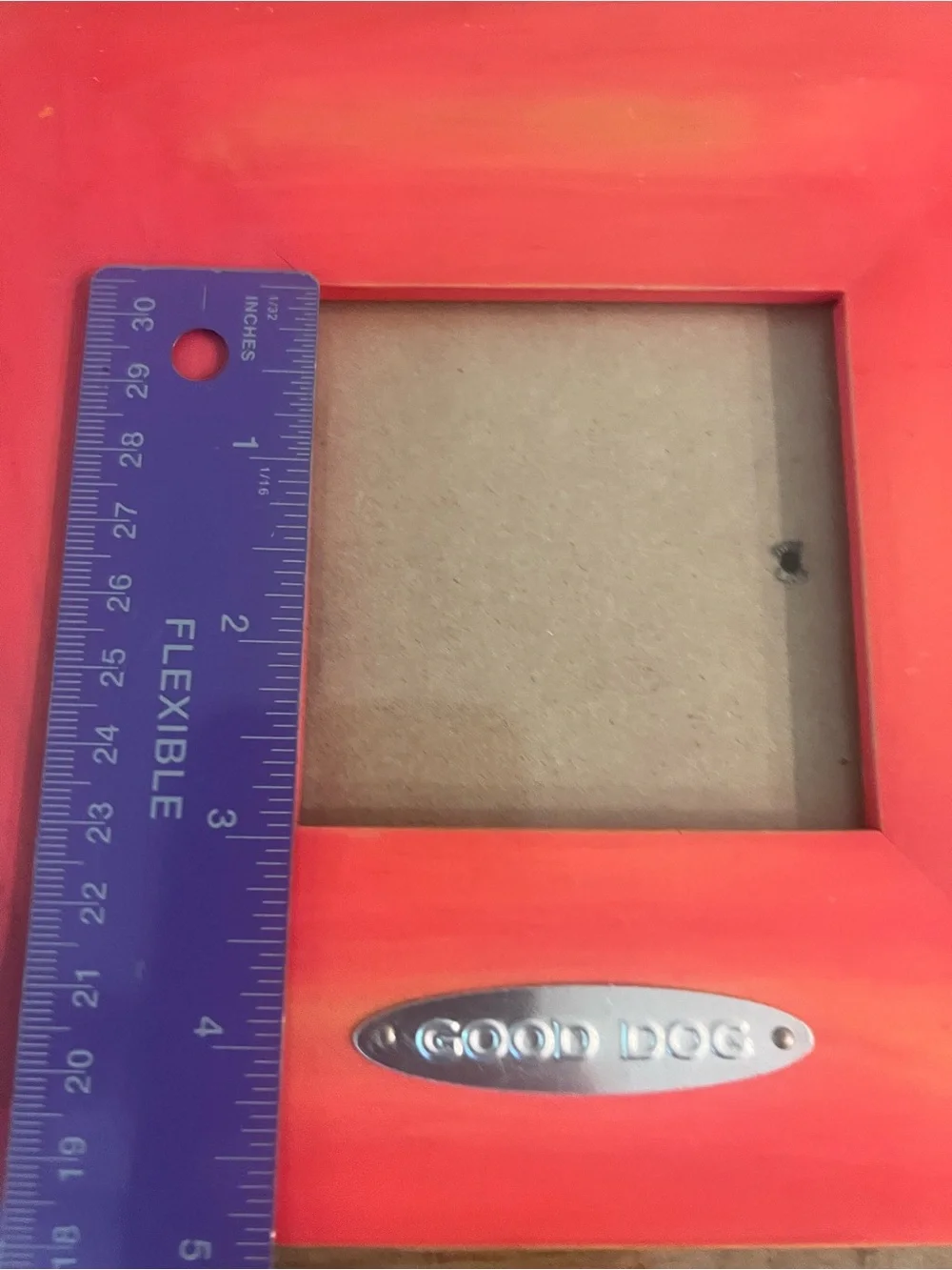 red/orange square photo frame features a 